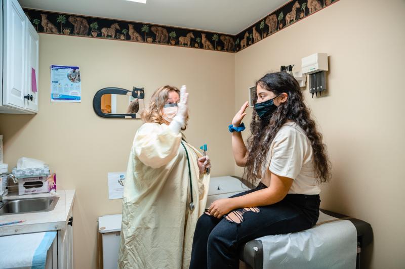 a girl and a medical provider high fiving